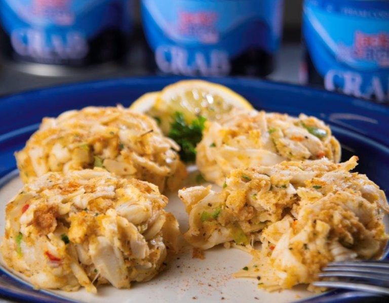 Crab cakes on a plate with a Jack's Catch can in the background.