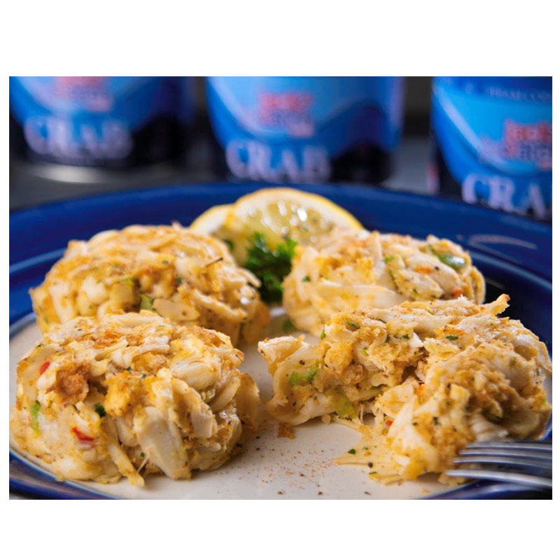 Crab cakes on a plate with a Jack's Catch can in the background.