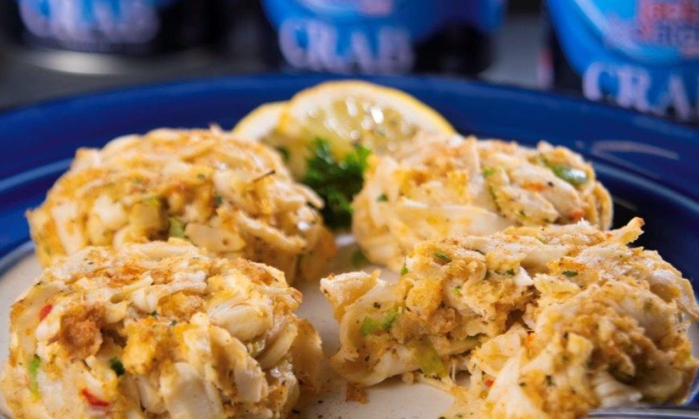 Crab cakes on a plate with a Jack's Catch can in the background.